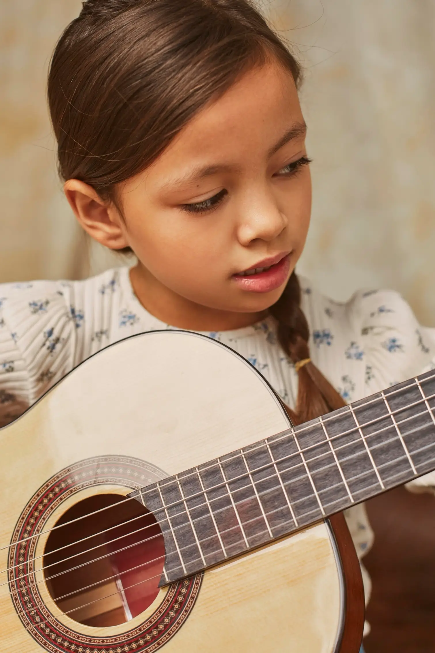 little-girl-learning-how-play-guitar-home+(1) (1)